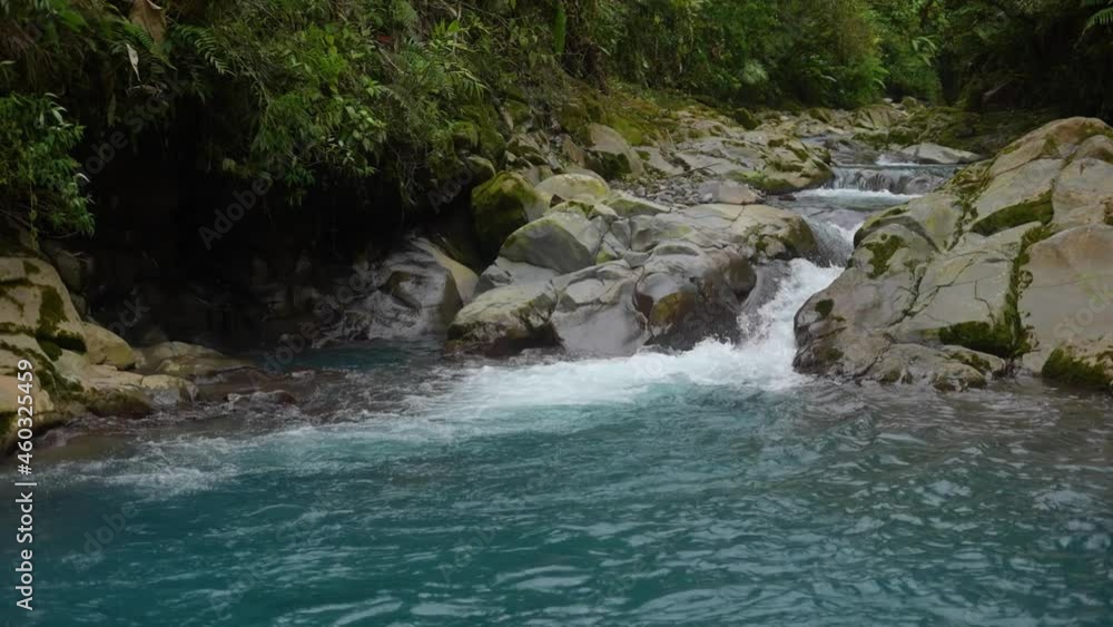 celestial river with creek between rocks in the rainforest of costa rica with blue water celestial river with creek between rocks in the rainforest of costa rica with blue water
