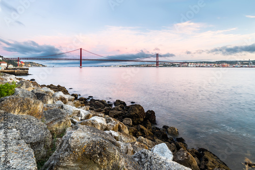 the 25 de Abril suspension bridge over Tagus river in Lisbon, Portugal at sunrise © Tereza