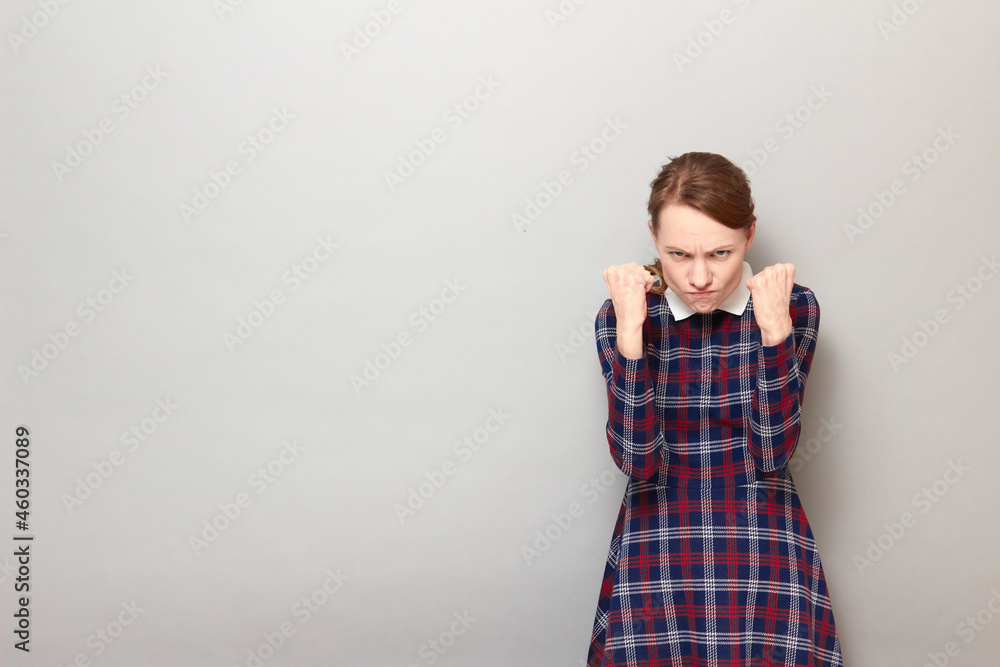 Portrait of angry furious girl raising fists up Portrait of angry furious girl raising fists up