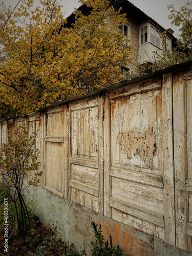 old wooden fence, house in autumn