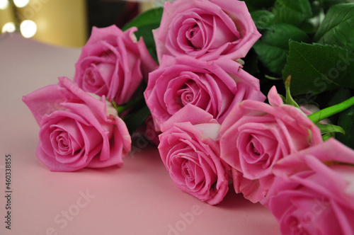 Bouquet of roses on pink background copy space 