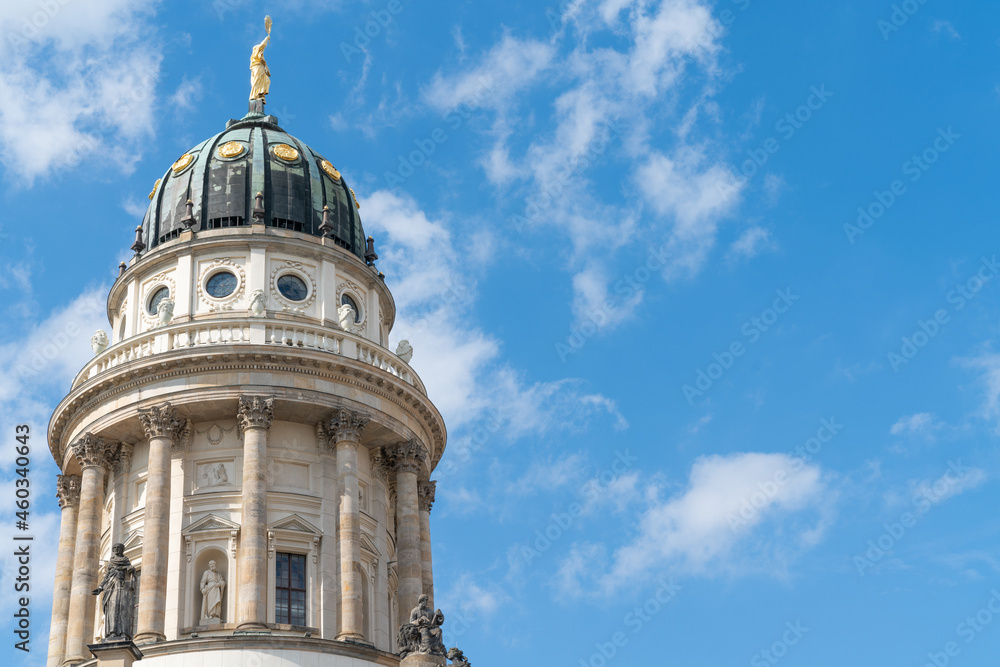 Structure and dome with gold statue on top of French Cathedral in Berlin district of Gendarmenmarkt, Germany Structure and dome with gold statue on top of French Cathedral in Berlin district of Gendarmenmarkt, Germany