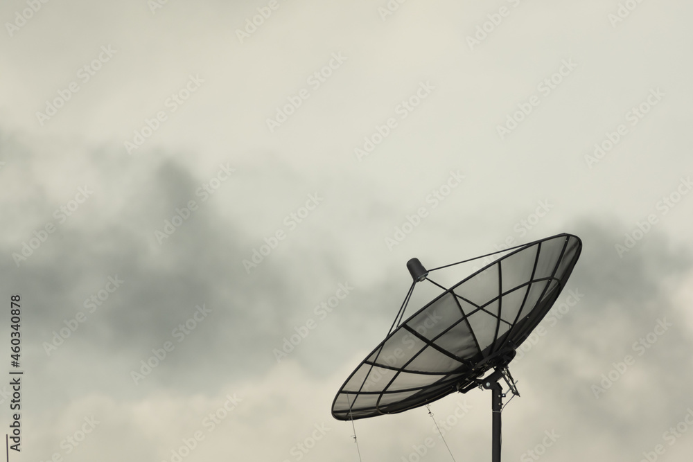 Satellite dish on building deck roof.Satellite receiver on sky and clouds background. Satellite dish on building deck roof.Satellite receiver on sky and clouds background.