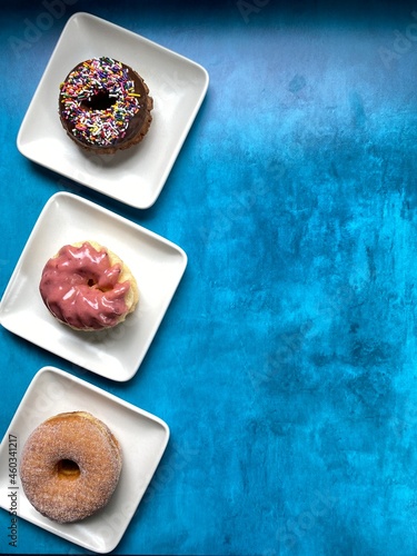 donuts on white plates with blue background