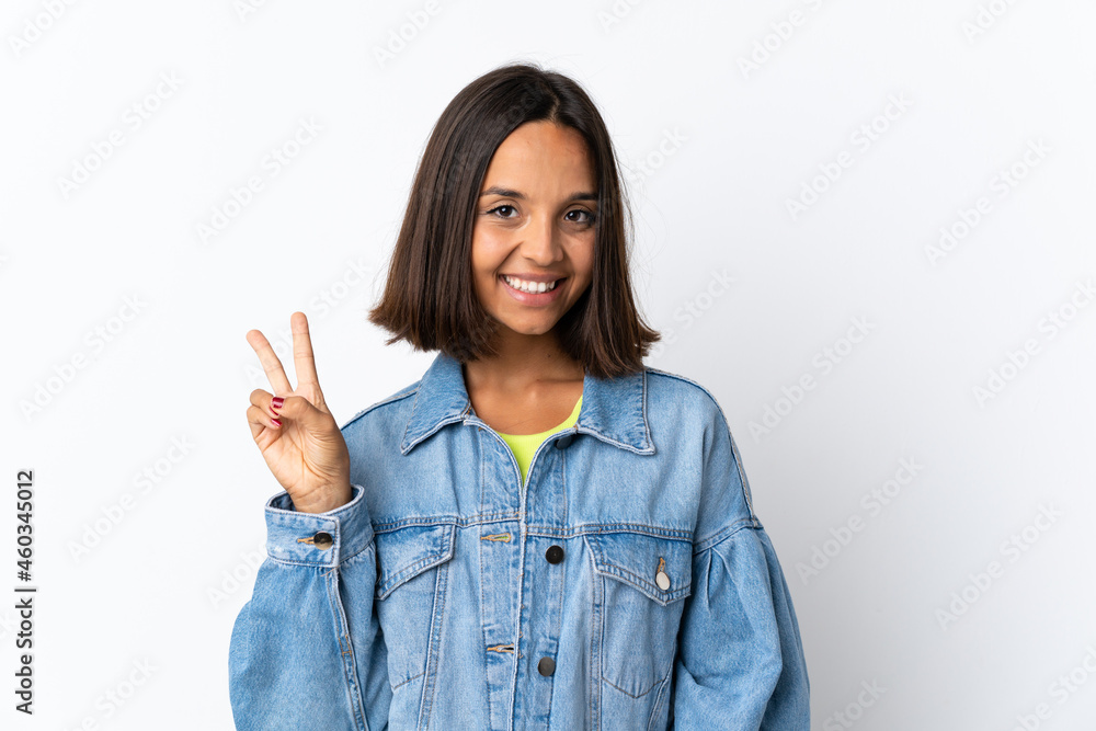 Young latin woman isolated on white background smiling and showing victory sign Young latin woman isolated on white background smiling and showing victory sign