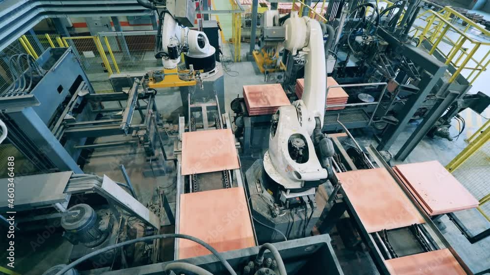Factory robots are piling copper sheets together Factory robots are piling copper sheets together