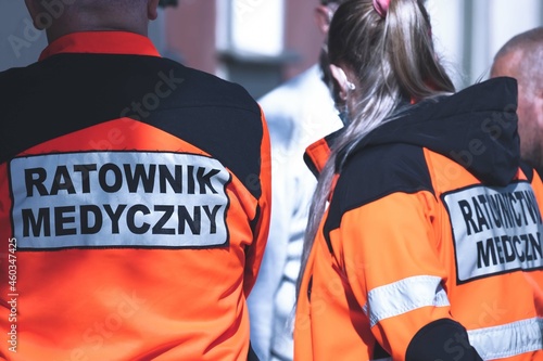 Polish paramedics team in action, wearing uniforms reading "Emergency Medical Service" in Polish ("Ratownik Medyczny")