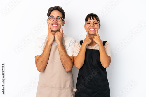 Restaurant mixed race waiters isolated on white background smiling with a happy and pleasant expression