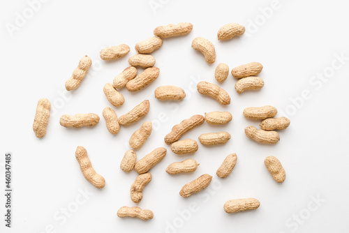Peanuts on a white background. Unpeeled peanuts. Peanuts in shells. 