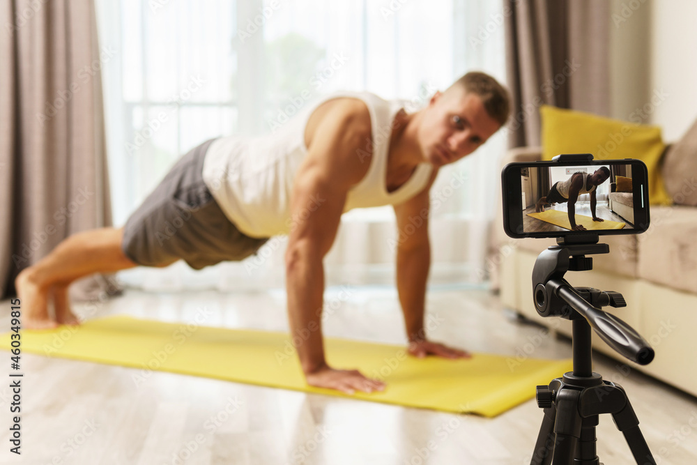 Fototapeta premium Fitness blogger streaming or recording video for his subscribers