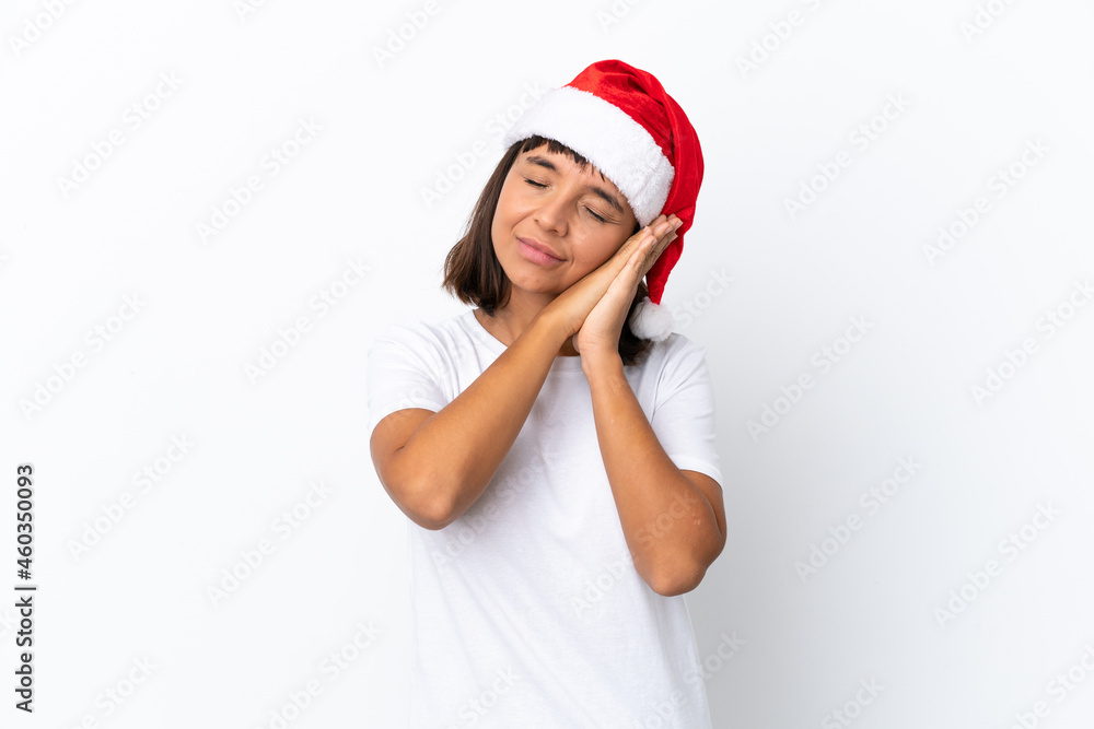 Young mixed race woman celebrating Christmas isolated on white background making sleep gesture in dorable expression Young mixed race woman celebrating Christmas isolated on white background making sleep gesture in dorable expression