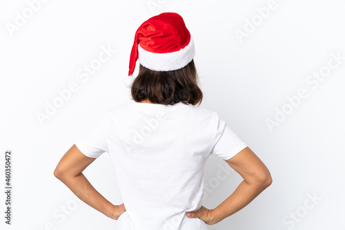 Young mixed race woman celebrating Christmas isolated on white background in back position