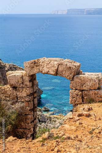 Cliffs and rocks of Maltese coastline. Sailing boats