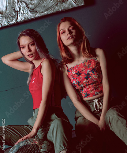 twins sisters in joggers and red tops