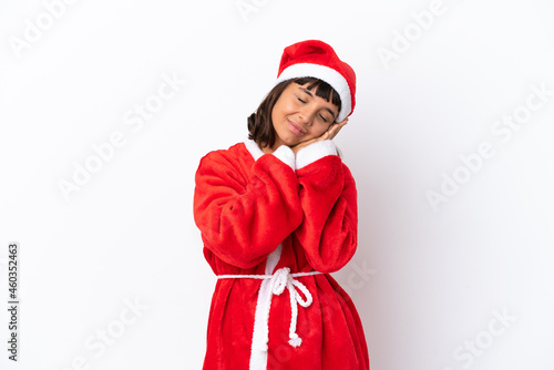 Young mixed race woman disguised as Santa Claus isolated on white background making sleep gesture in dorable expression