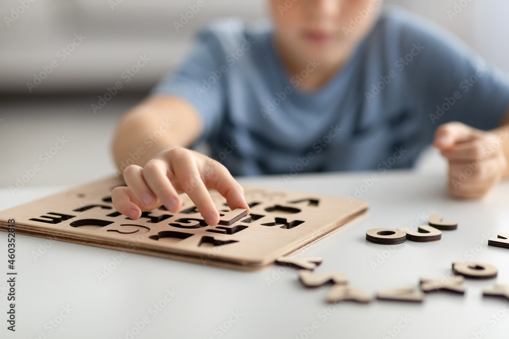 Cropped of kid playing with educational game, collacting letters Cropped of kid playing with educational game, collacting letters