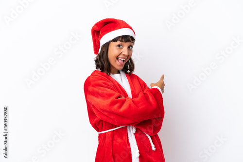 Young mixed race woman disguised as Santa Claus isolated on white background pointing back