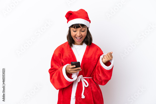 Young mixed race woman disguised as Santa Claus isolated on white background surprised and sending a message