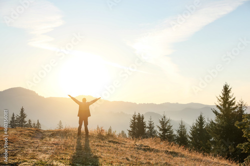 Man enjoying sunrise in mountains  back view. Space for text
