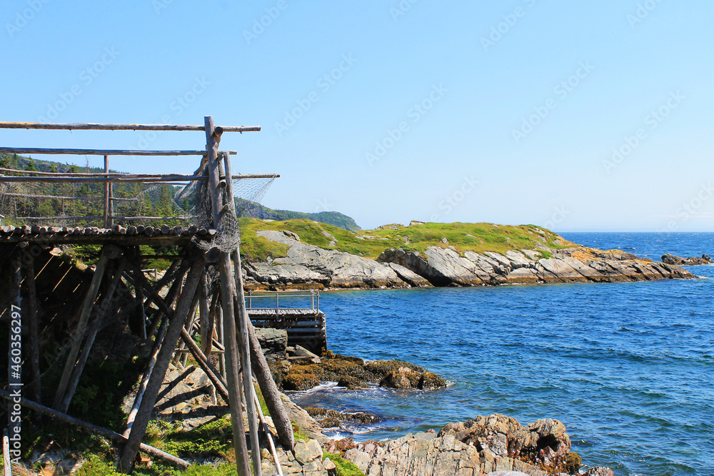 A fishing stage and pier on the rocky coastline of Newfoundland, on the Atlantic Ocean.