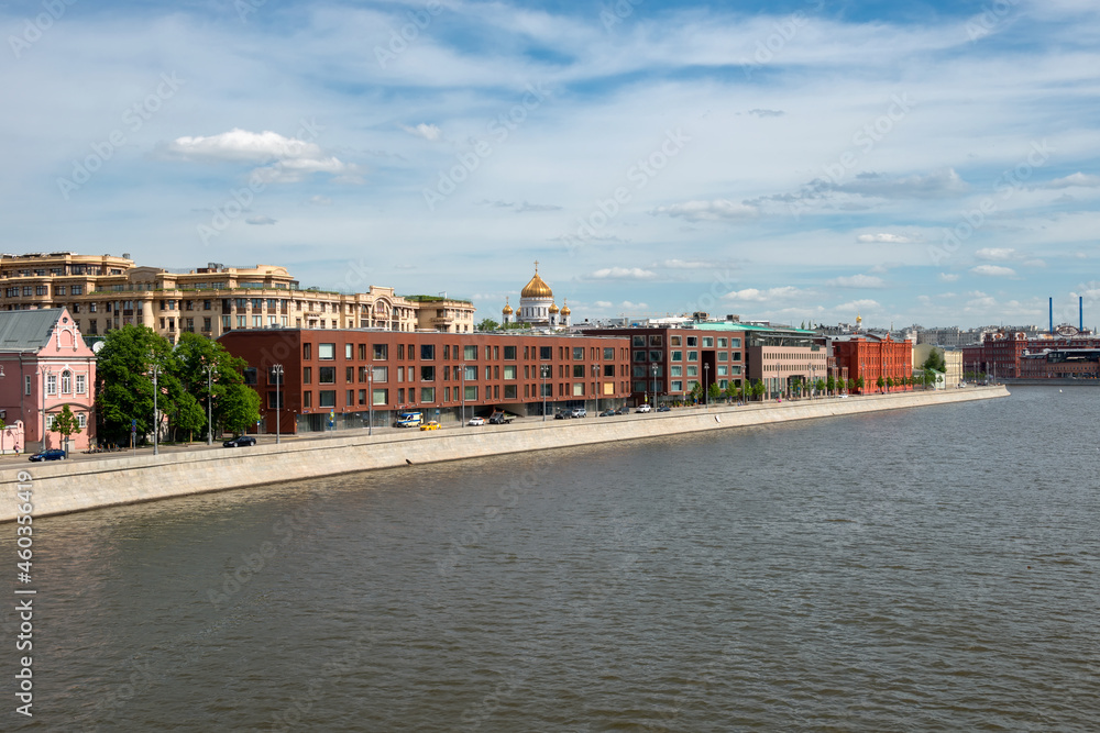 View of the dome of the Cathedral of Christ the Savior, houses on Prechistenskaya embankment and  the Moskva River in sunny morning Moscow