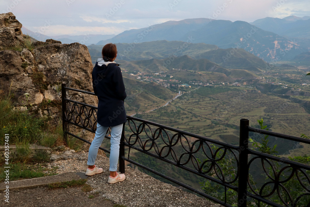 young woman on the top of the mountain enjoy the scenic view in Gunib, Dagestan