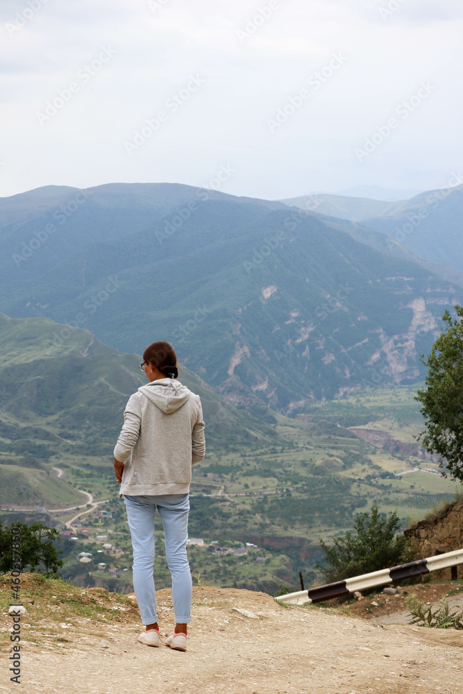 young woman on the top of the mountain enjoy the scenic view in Gunib, Dagestan