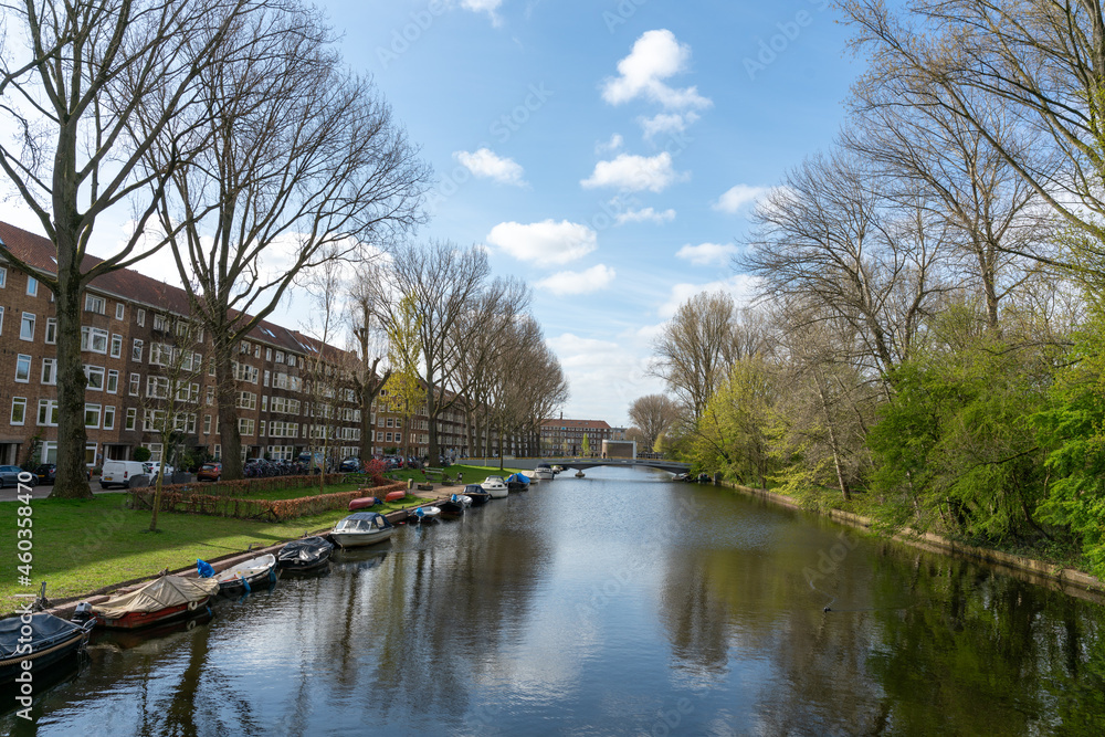 Boats along canal in Mercatorwijk in Amsterdam West in The Netherlands Boats along canal in Mercatorwijk in Amsterdam West in The Netherlands