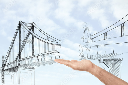 Vászonkép Man holding hand to help drawn businessman cross unfinished bridge, illustration