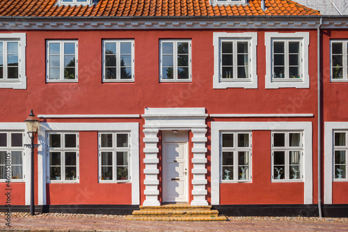 Red facade of a historic house in the center of Ribe, Denmark