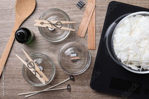 Flat lay composition with ingredients for homemade candles on wooden background photo