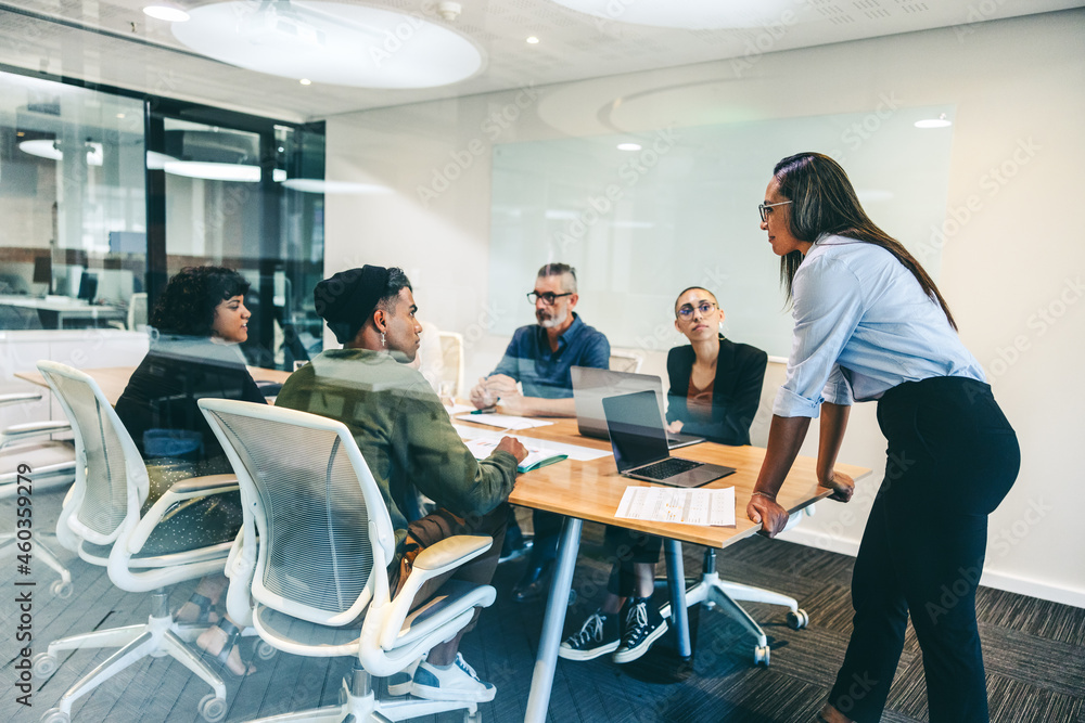 Female supervisor briefing her colleagues in a boardroom