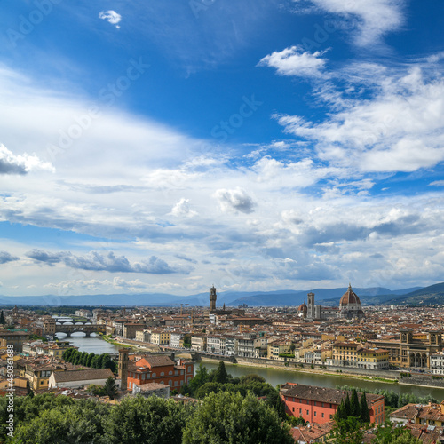 Beautiful panoramic view of Florence in a sunny day with blue sky and clouds. Italian panorama of a city in Tuscany. Top aerial landscape view of an ancient historical tourist destination in Europe. © Fabio Principe