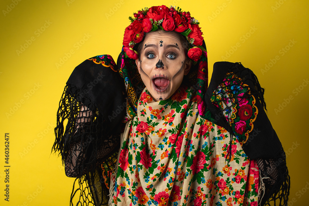 girl in the image of Kalavera Katrina close up shows various emotional gestures of the body, face, in a headscarf, on a yellow background, looks and sideways. Dia-de -los -muertos. Day of death. girl in the image of Kalavera Katrina close up shows various emotional gestures of the body, face, in a headscarf, on a yellow background, looks and sideways. Dia-de -los -muertos. Day of death.