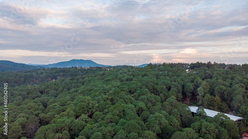 Aerial shot of sunrise in a beautiful green valley with surrounding mountains. Mazamitla, Jalisco, Mexico