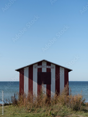 Red and white striped Beach House in Ærøskøbing on the island of Ærø or Aroe in Denmark. The changing room / hut / cabin is called Vandhytten or water hut.