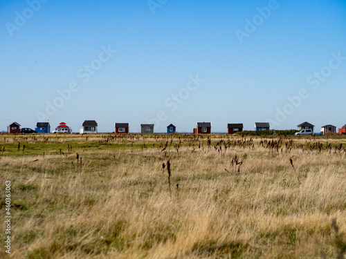 Beach Houses on a row in Ærøskøbing on the island of Ærø or Aroe in Denmark. Field in foreground