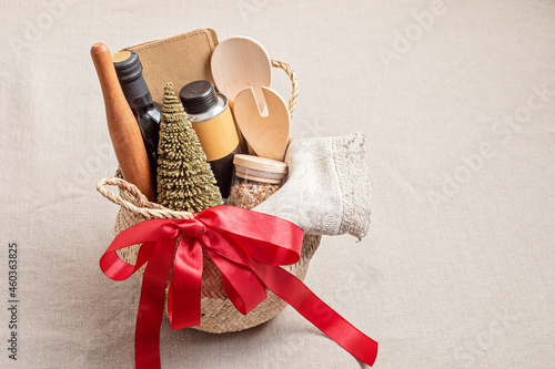 Refined Christmas gift basket for culinary enthusiats with bottle of oil, vinegar and kitchen utensils. Corporate or personal present for cooking lovers, foodies and gourmands. photo