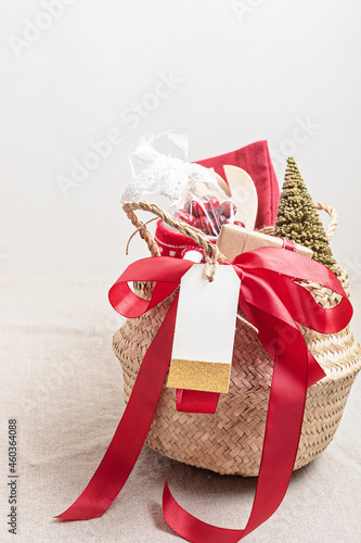 Refined Christmas gift basket for culinary enthusiats with mug, fruit tea and kitchen utensils. Corporate or personal present for cooking lovers, foodies and gourmands. photo