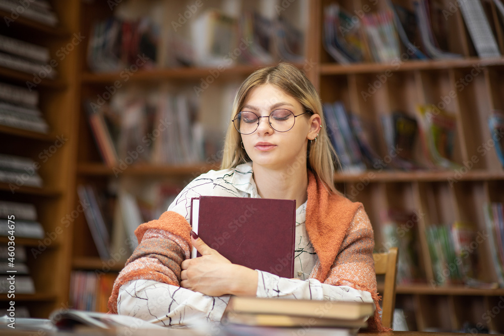 Beautiful smart blonde nerd girl in the library. Beautiful smart blonde nerd girl in the library.