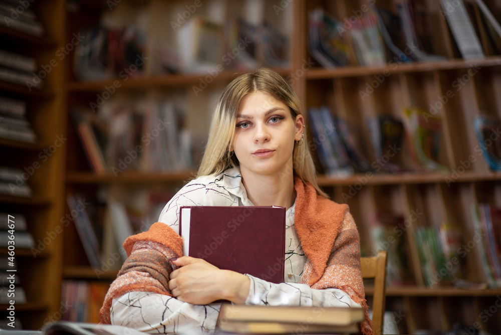 Beautiful smart blonde nerd girl in the library. Beautiful smart blonde nerd girl in the library.