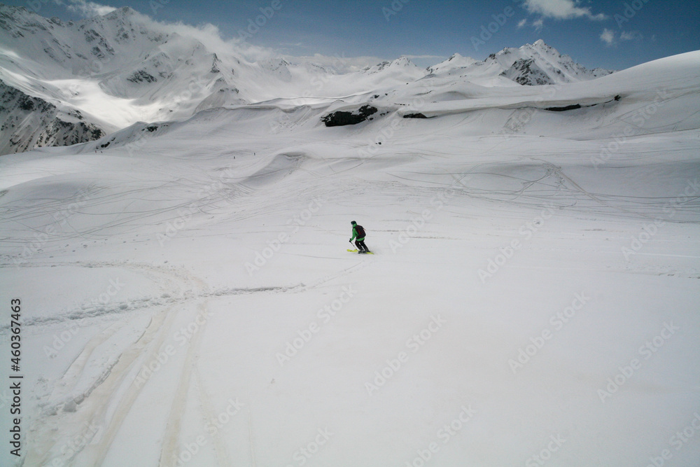 A young woman skiing in the Caucasus Mountains, Russia.