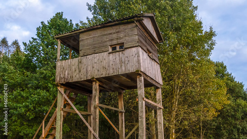 A shooting and observation tower for hunting in the forest at dusk. Active leisure concept. © kalyanby