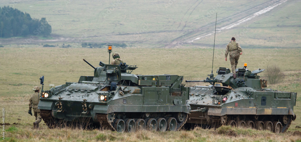REME soldiers army mechanized recovery vehicle FV512 preparing to tow a stricken Warrior infantry fighting vehicle FV510 tank on a military exercise Wiltshire UK REME soldiers army mechanized recovery vehicle FV512 preparing to tow a stricken Warrior infantry fighting vehicle FV510 tank on a military exercise Wiltshire UK