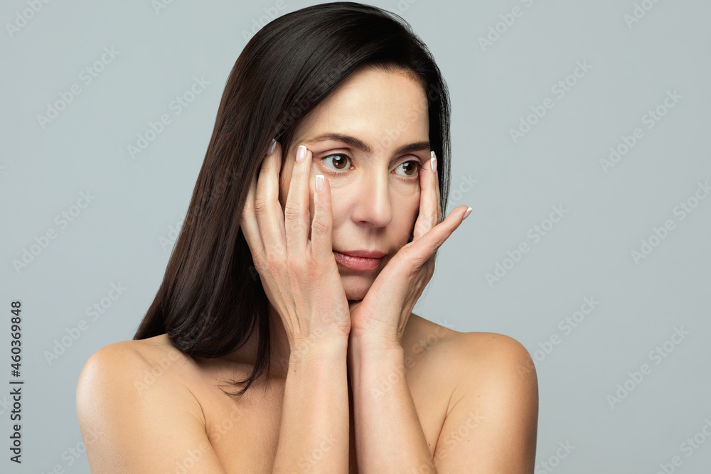 Beautiful middle aged woman on gray background Beautiful middle aged woman on gray background