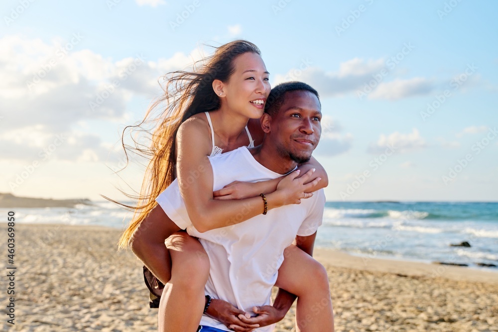 Young beautiful having fun couple on the sea background