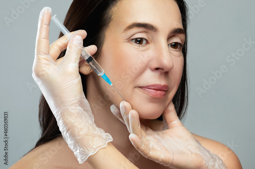 Middle aged woman receiving facial injection for skin rejuvenation