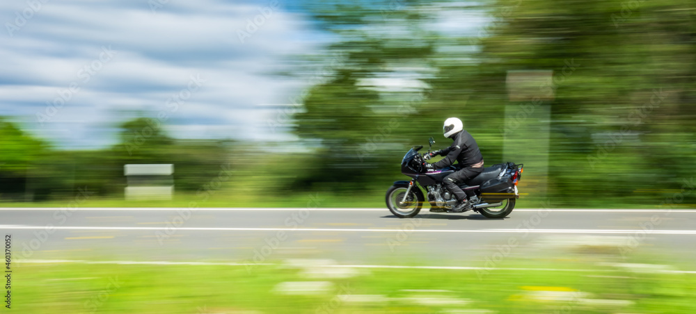 fast motorbike on the road riding. having fun riding the empty road on a motorcycle tour / journey - motion blur effect