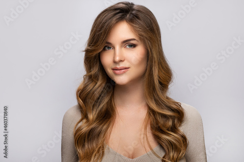 Fotografie Portrait of young pretty woman with a curly hairstyle