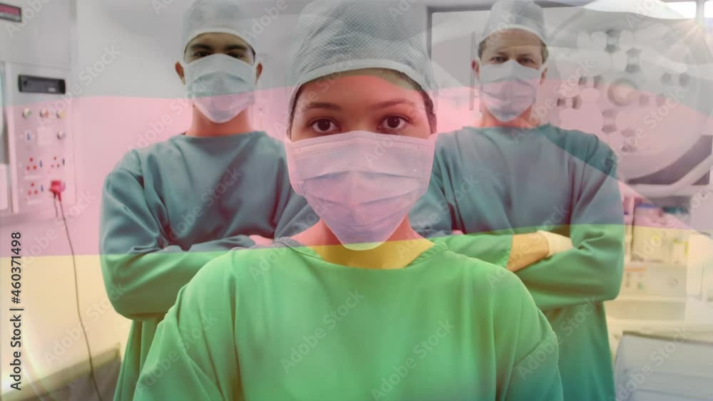 Animation of flag of germany waving over surgeons in operating theatre Animation of flag of germany waving over surgeons in operating theatre